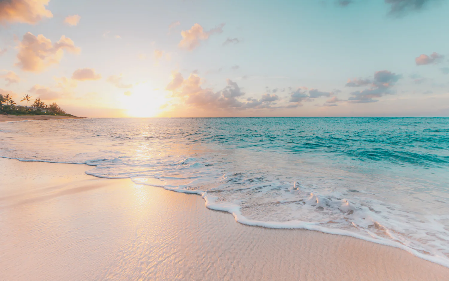 Turquoise lagoon and white sand at sunrise