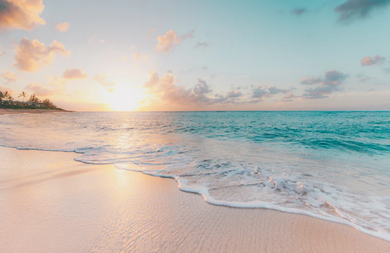 Turquoise lagoon and white sand at sunrise