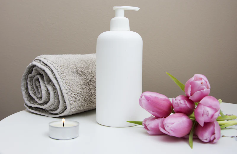 Spa towels, a candle and flowers